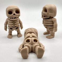 three different types of fake human bodies on a white surface, with one laying down and the other standing up