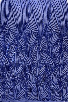 blue sequins and beaded fabric with wavy lines on white background, closeup