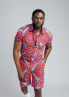 Style#M2015TRC Step out with confidence in our Keyon Men's African Print Button-Up Short Sleeve Shirt in Turquoise Red Circles. This dynamic shirt is a statement piece for the contemporary man who embraces bold style. Shop the matching items. *Disclaimer* Please refer to the fabric image for the true color of this product. Features: Collared Neckline Pocket at Chest 100% Cotton Designed in the USA, imported *Print placement may vary* Care Instruction: Hand Wash Cold. Mild Detergent. Do Not Bleac Vibrant Multicolor Short Sleeve Shirt, Casual Red Shirt With Vibrant Print, Casual Fitted Shirt With Vibrant Print, Vibrant Red Short Sleeve Top, Bold Style, Ankara Fabric, Print Shorts, Print Placement, Mens Fall