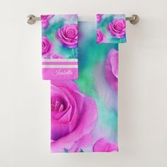 two towels hanging on a towel rack with pink roses painted on the front and back