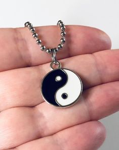 "Yin & Yang necklace, Yin and Yang necklace, unisex black and white with silver charm, on a ball chain necklace which is STAINLESS STEEL. Boho chic bohemian. Occult esoteric jewelry 💕 Yin & Yang is a concept of dualism with its roots in Taoism/ philosophy. The Yin or dark side is associated with shadows, femininity & the trough of a wave, the Yang or light side represents brightness, passion & growth, both sides present duality, both sides work together. *this is a super cute ne Symbolic Black Necklace With Adjustable Chain, Symbolic Black Jewelry With Adjustable Chain, Black Symbolic Jewelry With Adjustable Chain, Black Hypoallergenic Spiritual Jewelry, Black Stainless Steel Pendant Charm Necklace, Symbolic Black Stainless Steel Necklace, Black Clavicle Chain Charm Necklace, Trendy Black Nickel-free Necklace, Adjustable Hypoallergenic Black Necklace