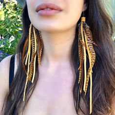 "-Embrace your inner Freebooter with these leather and feather pirate-style earrings. Supple deerskin leather, coque feathers, and antique-brass chains brush the chest at 10\" total length. -Coque feathers come from unique roosters that have been bred by fly fishermen, who use these beautiful feathers as fishing lures. Sustainably sourced in the USA. -Deerskin leather is also sustainably sourced in the USA. -Feathers and leather are fine if they get wet. -Earwires are antique-brass. Goldfill ear Pirate Earrings, Feathered Earrings, Feather Earrings Diy, Feather Ideas, Leather Feathers, Product Inspiration, Diy Leather Earrings, Pirate Fashion, Goose Creek