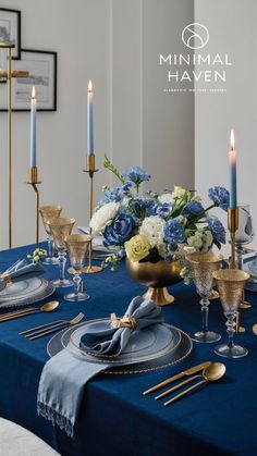 a table set with blue and gold place settings