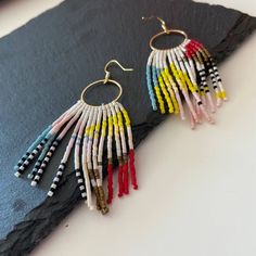 "These beaded hoops earrings with colorful abstract fringe are made of high quality Japanese beads. They are lightweight and comfortable. These beaded earrings are an amazing gift for special occasions: holidays, birthdays, anniversaries, Christmas, Valentine's Days and more. It can also be jewelry for the bride or bridesmaids at a boho wedding. This pair is a mix of ethnicity and modern casual style. I create for women who love to feel completely different. Colors: white,blue, pink, yellow, red.  -------------------------------------------- ✦ The Details: ✔ Made with quality Japanese beads ✔ Made using strong bead weaving thread.  ✔ Lenght: app. 3.1 inches ✔ 24k gold plated earrings hooks There may be some color discrepancies which is due to the different monitor settings ✦ All  earrings Handmade Modern Dangle Beaded Earrings, Modern Handmade Beaded Dangle Earrings, Modern Handmade Dangle Beaded Earrings, Multicolor Fringe Chandelier Earrings For Gift, Handmade Artsy Dangle Hoop Earrings, Trendy Multicolor Handmade Chandelier Earrings, Artsy Dangle Beaded Earrings With Ear Wire, Artsy Beaded Dangle Earrings, Artsy Dangle Beaded Earrings