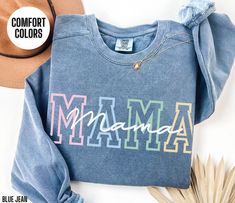 You will love this Comfort Colors sweatshirt for your Mama.  This crewneck sweatshirt has a colorful design on the front of the sweatshirt that says Mama.  This minimalist sweater will be perfect for your Mama's Birthday, Mama's Christmas or Mom's Mother's Day.  Your Mama will love wearing this trendy sweater this fall and winter season. Attn: I am the original creator of this design.  If you see this design for sale anywhere else, it has been stolen.   Luxurious comfort and style are what this Multicolor Crew Neck Sweatshirt For Loungewear, Mother's Day Graphic Print Crew Neck Sweatshirt, Casual Cotton Sweatshirt For Birthday, Trendy Letter Print Sweatshirt For Mother's Day, Casual Slogan Sweatshirt For Mother's Day, Casual Mother's Day Slogan Sweatshirt, Birthday Letter Print Relaxed Fit Sweatshirt, Casual Text Print Sweatshirt For Mother's Day, Relaxed Fit Letter Print Sweatshirt For Birthday