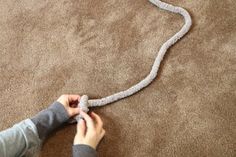 a person is cleaning the carpet with a vacuum and a cord attached to it in order to get ridi