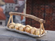 a tray filled with food sitting on top of a stone wall next to a brick building