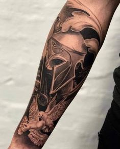 a man's arm with a helmet on it and an eagle in the middle