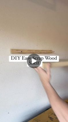 a person holding a wooden stick in front of a sign that says diy easy crap wood