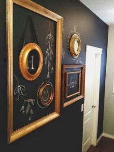 there are two framed pictures on the wall and one has a gold frame with an anchor