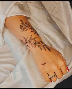 a woman's foot with flowers on it and the word hope written in black ink