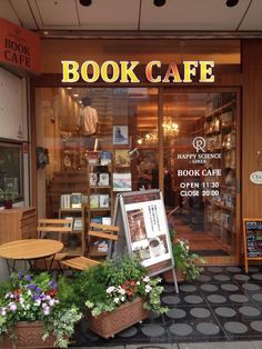 a book cafe with potted plants outside