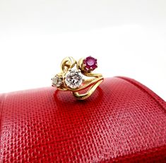 Contemporary Estate Custom 14K 585 Yellow Gold Diamond & Ruby Ring, Size 5 1/2. This is a custom made ring from three antique stones. The center largest stone is a 1/2 Carat Diamond. Flanked by a .20 Carat European Cut Diamond and a 1/4 carat antique ruby. Stunning design and color. The largest diamond is nearly flawless. The smaller diamond has a tiny chip. Would make a very creative engagement ring. The ring is hallmarked 14K for gold content. Weighs 4.3 grams. Excellent clean condition. C Heirloom Yellow Gold Multi-stone Diamond Ring, Vintage Yellow Gold Three-stone Jewelry, Vintage Yellow Gold Three Stone Jewelry, Vintage Yellow Gold Three Stone Rings, Heirloom Three Stone Ruby And Diamond Ring, Heirloom Three Stone Ruby Ring With Diamonds, Heirloom Yellow Gold Three Stone Ring, Heirloom Three-stone Ruby And Diamond Ring, Heirloom Three-stone Ruby Ring With Diamonds