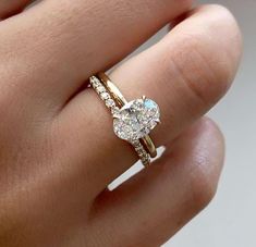 a woman's hand with a ring on it and a diamond in the middle