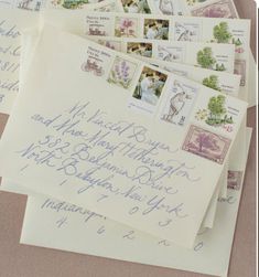 several envelopes with stamps on them are laying next to each other and the letters have been written in cursive writing