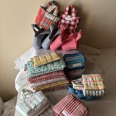 many different types of cloths are stacked on top of each other and placed next to each other