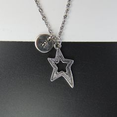 ♥ Star Necklace Star charm Necklace Valentine Gift Star Gift Personalized Necklace Initial Necklace ♥ This is a beautiful star charm with hand stamped initial charm on a stainless steel chain, You able to choose initial from a drop down menu, ♥ You will receive 1 necklace ♥ Star charm 26x15 mm ♥ Initial charm 10 mm choose from a drop down menu ♥ Stainless steel chain 18 inches If you need help with your first purchase on Etsy, here is a helpful guide : http://www.etsy.com/help/article/339 ♥ addi Metal Star Charm Necklace In Star Shape, Star Charm Initial Pendant Necklace As Gift, Star-shaped Charm Necklaces For Gifts, Personalized Sterling Silver Star Charm Necklace, Silver Star Necklace For Mother's Day, Stainless Steel Star Charm Necklace, Silver Star-shaped Personalized Necklace, Silver Star-shaped Charm Necklace, Silver Star Shaped Charm Necklace