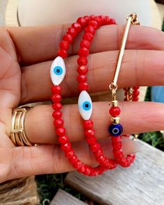 Mother of Pearl Freshwater Shell Evil Eye 4mm Red 4mm Porcelain beads  14kt Gold filled Lobster clasp and components 14Kt gold plated charm bar  Shell Eye Eye will give you a sense of tranquility with natural soft colors white & blue  Represent defense of evil from those that wish bad on you . Beautiful vibrant red porcelain beads  Similar to the red string in beads  Protection over anyone wishing bad on you  Beautifully packaged (HANDMADE Please measure wrist & message wrist size  Also which bracelet you prefer  Example : Wrist 6.5 Red bar or  Wrist 6.0 Evil eye  Thank you for supporting small businesses 🧿🪬 Colorful Beads Red Evil Eye Bracelet, Red Evil Eye Round Bead Jewelry, Red Evil Eye Round Beads Jewelry, Red Beaded Evil Eye Bracelet, Charm Bar, Red Porcelain, Glass Evil Eye, Red Bar, Eye Eye