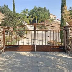 a gated driveway leading to a house