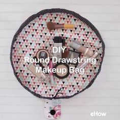 a round tray with makeup on it and the words diy round drawing make up bag