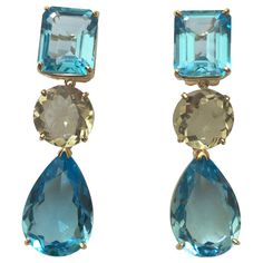 18kt Yellow Gold Geometric three stone drop Earring with Emerald Cut Blue Topaz, Round Green Amethyst and Pear shaped Blue Topaz Drop. The Earring measures 1 and 3/4" inches long and 1/2" wide at its most wide part. The Geometric earring can be made for Clip or Pierced earrings. This earring can also be made in White Gold with and combination of stones. Please contact me with any questions you may have at all. Green Amethyst Jewelry, Month Gemstones, Purple Drop Earrings, Blue Topaz Jewelry, Sparkly Jewelry, Purple Jewelry, Earrings Purple, Blue Topaz Earrings, Purple Earrings