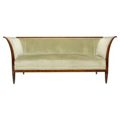 an antique style couch with wood trim and velvet upholster