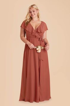 the bridesmaid wears an orange dress with a bow at the waist and sleeves