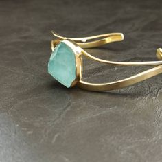 Hand made, sterling silver, light blue agate, cuff bracelet, with a 18k yellow gold finish. Modern Yellow Gold Aquamarine Jewelry, Modern Aquamarine Yellow Gold Jewelry, Formal Chalcedony Jewelry With Polished Finish, Elegant Gold Aquamarine Bracelet, Formal Yellow Gold Chalcedony Jewelry, Adjustable Gold Chalcedony Jewelry, Modern Turquoise Bracelet Jewelry, Aquamarine Bracelet Jewelry As A Gift, Aquamarine Bracelet Jewelry Gift