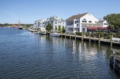 boats are parked along the water in front of houses