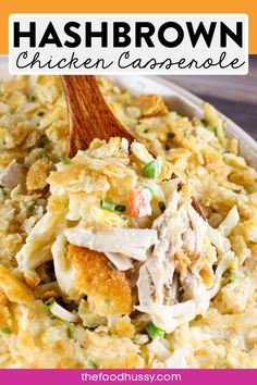 chicken and rice casserole in a white bowl with a wooden spoon on top