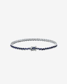 Embrace the refined charm of our Princess Mini Tennis Bracelet. This exquisite piece showcases offset princess-cut sapphires, each one carefully selected to enhance the bracelet's overall elegance. Featuring 3.20 carats of princess-cut dark blue sapphires, it offers versatility for stacking or stands out gracefully as a solo piece. Details 18k white gold 3.20 carats of 1.5x1.5mm princess-cut dark blue sapphires Bracelet measures 7" inches in length Box clasp with safety lock fastening 3mm width Classic Sapphire Tennis Bracelet With Prong Setting, Sapphire Tennis Bracelet Fine Jewelry With Prong Setting, Classic Sapphire Tennis Bracelet With Brilliant Cut, White Gold Sapphire Gemstone Tennis Bracelet, Sapphire Color Brilliant-cut Cubic Zirconia Bracelets, Elegant Sapphire Tennis Bracelet With Brilliant Cut, Classic Sapphire Gemstone Tennis Bracelet, Sapphire Tennis Bracelet With Prong Setting, Luxury Sapphire Tennis Bracelet With Brilliant Cut