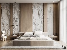 a large bed sitting in the middle of a bedroom next to a wall with rocks on it