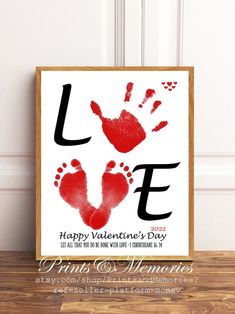 a valentine's day card with two hand prints