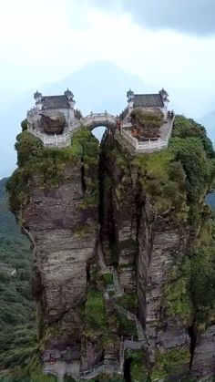 two buildings on top of a rock formation