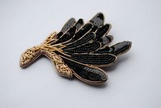 "The beaded black and gold brooch shaped like a gorgeous wildflower and decorated with sequin embroidery. You can pin this statement brooch to your hat or wear it to affix a scarf. You can even use this embroidered flower brooch as a stylish hair accessory. You can wear your sequin brooch in hundreds of ways, your only limit is your imagination! Also, it would be a beautiful gift for a mother or wife, who loves beadwork jewelry.  Materials: chenille, seed beads, crystals, spun gold. Size: 2.75\" Sequin Brooch, Beadwork Jewelry, Statement Brooch, Jewelry Materials, Embroidered Brooch, Sequin Embroidery, Gold Brooch, Bead Work Jewelry, Gold Brooches