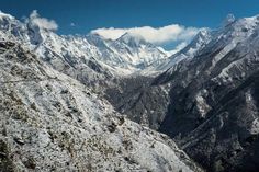 the mountains are covered in snow on a sunny day