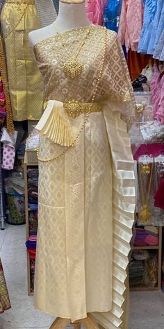 a mannequin is dressed in an elaborate dress