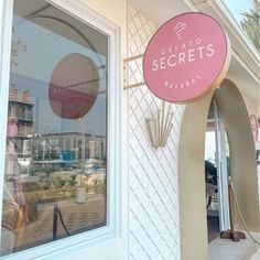 a sign that is on the side of a store front window and it says, get to secrets national