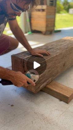 a man sanding down a piece of wood