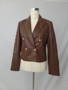 Cuteness to the max! This faux leather cropped moto jacket gives you the look of leather without the cruelty – plus the buttons in front make 'em do a double take! Dare to layer on and show the world who's boss! Fit : True to size 55% PU, 45% POLYESTER Lined Button closure Fitted Brown Leather Jacket With Double Button Closure, Trendy Brown Leather Jacket With Button Closure, Trendy Brown Blazer With Buttons, Chic Brown Leather Jacket With Buttons, Brown Leather Cropped Jacket With Long Sleeves, Brown Leather Long Sleeve Cropped Jacket, Fitted Faux Leather Jacket With Buttons, Trendy Brown Leather Jacket For Office, Fitted Brown Biker Jacket With Button Closure