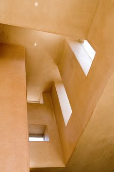 Skylights & cutout clerestory windows in stunning Los Angeles home create a play of shadows & natural light throughout the day. Hillside Houses