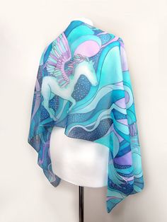 Hand painted scarf with Pegasus made of natural silk, in purple - blue - turquoise color set. This fantasy designer scarf is made to order. The Pegasus is a magical creature, a winged horse symbolizing wisdom and fame and more recently poets' inspiration (so imagine what a lovely gift the scarf would made for your poet friend). The Pegasus scarf depicts the winged horse flying with two peacocks on a starry, cloudy night sky. It is composed with tones of cool blue and turquoise, soft pastel mint Blue Shawl Scarf For Gift, Bohemian Blue Silk Scarf Gift, Bohemian Blue Silk Scarf As Gift, Bohemian Blue Silk Scarf For Gift, Blue Hand Painted Bohemian Silk Scarf, Blue Bohemian Hand Painted Silk Scarf, Bohemian Blue Hand Painted Silk Scarf, Artistic Handmade Blue Silk Scarf, Artsy Blue Scarf As A Gift