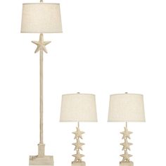 two lamps and a table lamp with white linen shades on the sides, one is starfish