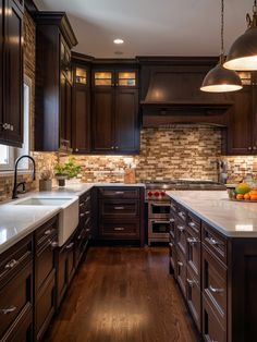 a kitchen with dark wood cabinets and white counter tops, along with wooden flooring