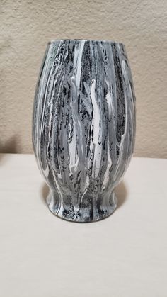 a black and white vase sitting on top of a table