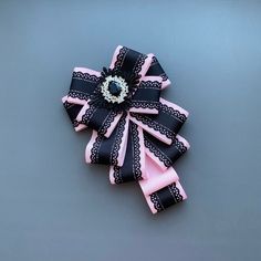 a pink and black hair bow sitting on top of a table