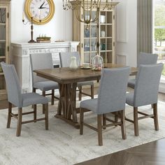 a dining room table and chairs with a clock on the wall in the back ground