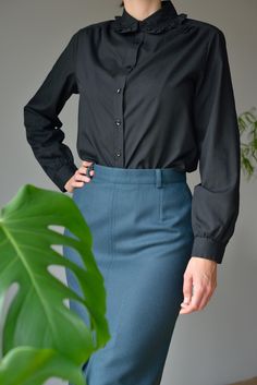 Frill-trim-collar cotton blend shirt in black. Shirt in an airy cotton blend weave with frill trimmed collar. Regular fit with buttons down the front, cuffed sleeves and gently rounded hem. - Closure - button up - Great vintage condition - Regular fit BRAND: Carat Made in Hong Kong MATERIAL: 65% Polyester 35% Cotton SIZE Marked as 42. Regular fit for S (small) size. MEASUREMENTS Shoulders: 41cm = 16,1" Chest: 50cm = 19,7" Waist: 48cm = 18,9" Length: 64cm = 25,2" Sleeve length: 60cm = 23,6" ✂ --- Button Shirts, Bib Collar, Blouse Black, Silk Shirt, Button Shirt, Trouser Jeans, Cuff Sleeves, Black Blouse, Black Stripes