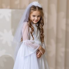 When it comes to a special occasion like a First Communion, finding the perfect dress and veil for your little girl is essential. A white First Communion dress and veil are traditional choices that symbolize purity and grace. For a classic and elegant look, consider opting for a tulle flower girl dress. The delicate fabric adds a touch of whimsy and creates a dreamy silhouette as your daughter walks down the aisle. The soft layers of tulle give the dress an ethereal feel, making it perfect for this sacred occasion. Princess Tulle Wedding Dress For First Communion, Tulle Princess Wedding Dress For Confirmation, White Princess Tulle Gown, First Communion Tulle Gown, Princess Tulle Baptism Dress For First Communion, Princess Style Tulle Baptism Dress For First Communion, White Tulle Princess Dress For First Communion, Princess Style Wedding Dress For First Communion, White Princess Tutu Dress For Confirmation