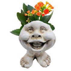 a white statue with flowers in it's head